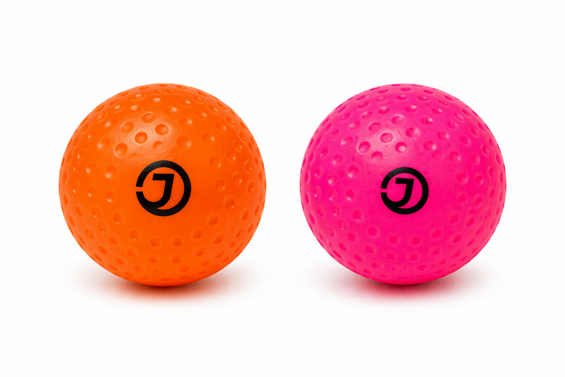 Justa Dimple Light Practice Hockey Balls in Pink and Orange | Lightweight 3.5oz balls for junior players